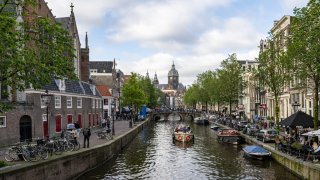 Tourists visiting the city take boat trips on the canals in Amsterdam, Netherlands on May 25, 2024.