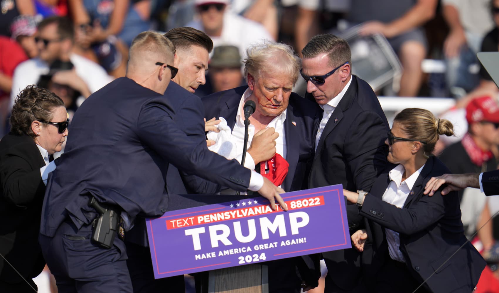 Republican presidential candidate former President Donald Trump is helped off the stage at a campaign event in Butler, Pa., Saturday, July 13, 2024.