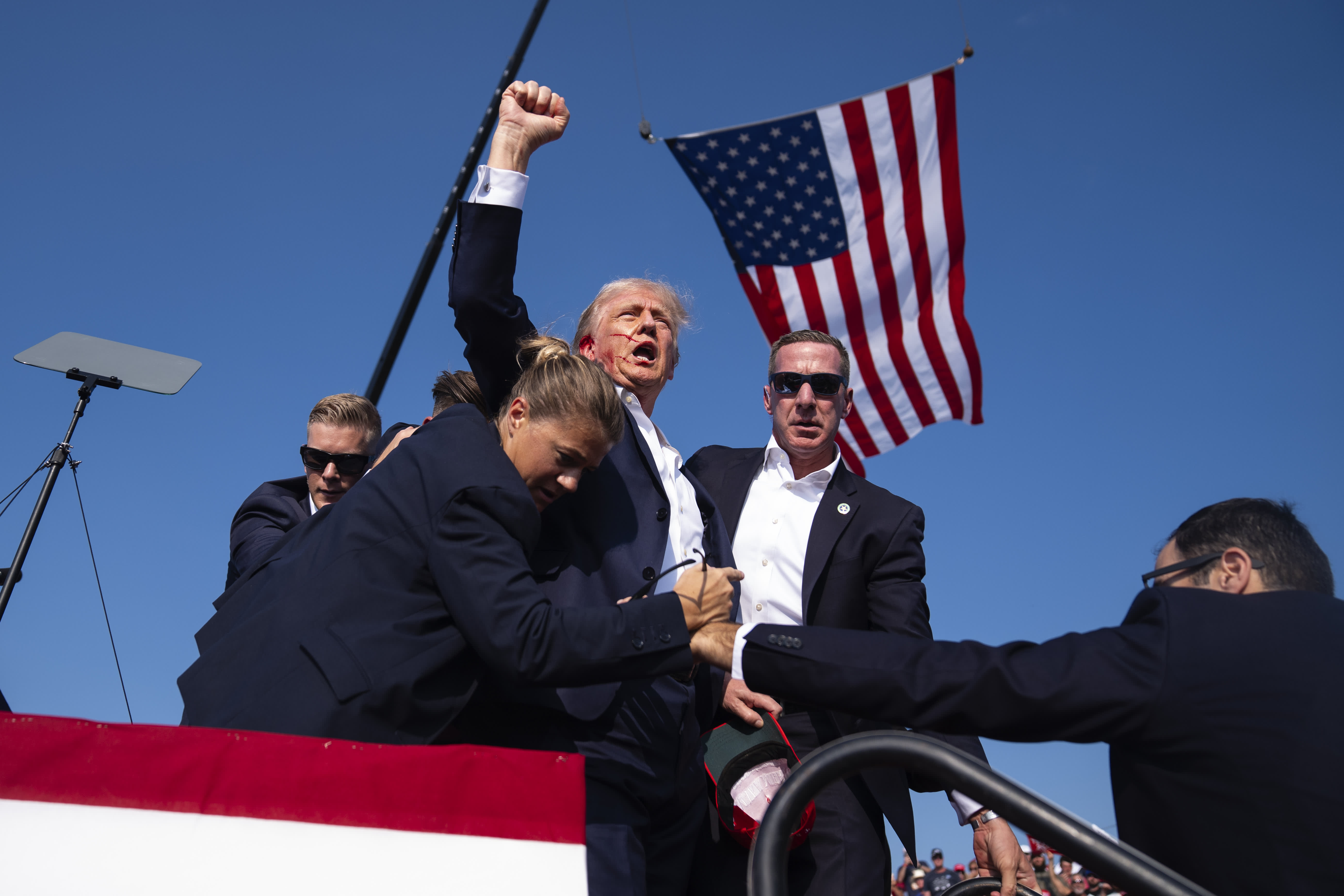 Republican presidential candidate former President Donald Trump is surrounded by U.S. Secret Service agents at a campaign rally, Saturday, July 13, 2024, in Butler, Pa.