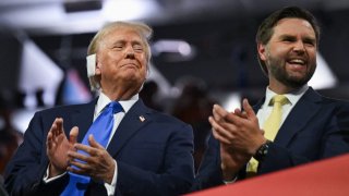 Republican presidential nominee and former U.S. President Donald Trump and Republican vice presidential nominee J.D. Vance applaud on Day 2 of the Republican National Convention (RNC), at the Fiserv Forum in Milwaukee, Wisconsin, U.S., July 16, 2024.