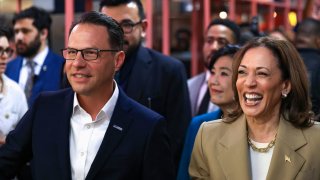 U.S. Vice President Kamala Harris and Pennsylvania Governor Josh Shapiro react during a visit to the Reading Terminal Market in Philadelphia, Pennsylvania, U.S., July 13, 2024. 