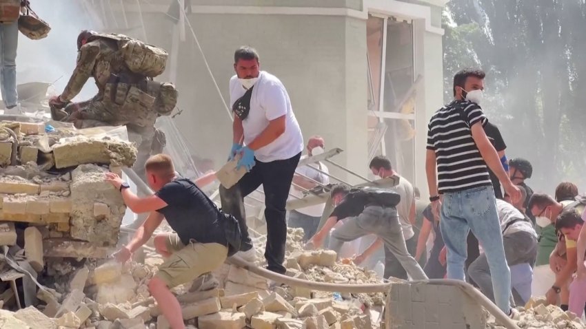 People remove rubble after missile strike at children's hopsital