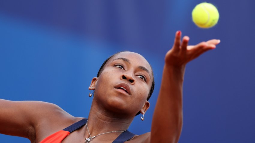 Coco Gauff serves a tennis ball