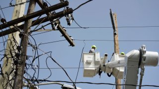 FILE - A brigade from the Electric Power Authority repairs distribution lines