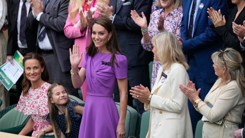 Kate, Princess of Wales waves to the crowd from the Royal Box, with her daughter Princess Charlotte, and her sister Pippa Matthews, left, looks on ahead of the men's singles final at the Wimbledon tennis championships in London, Sunday, July 14, 2024.