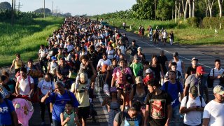 Migrants walk along the highway through Suchiate, Chiapas state in southern Mexico.