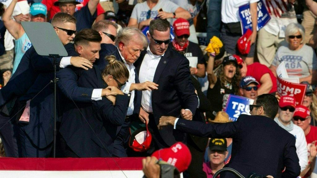 Republican candidate Donald Trump is seen with blood on his face surrounded by secret service agents as he is taken off the stage at a campaign event at Butler Farm Show Inc. in Butler, Pennsylvania, July 13, 2024.