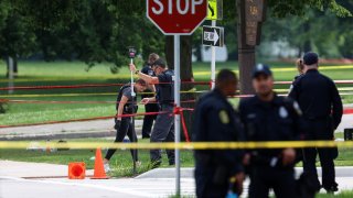 Police investigate a crime scene where a man was fatally shot