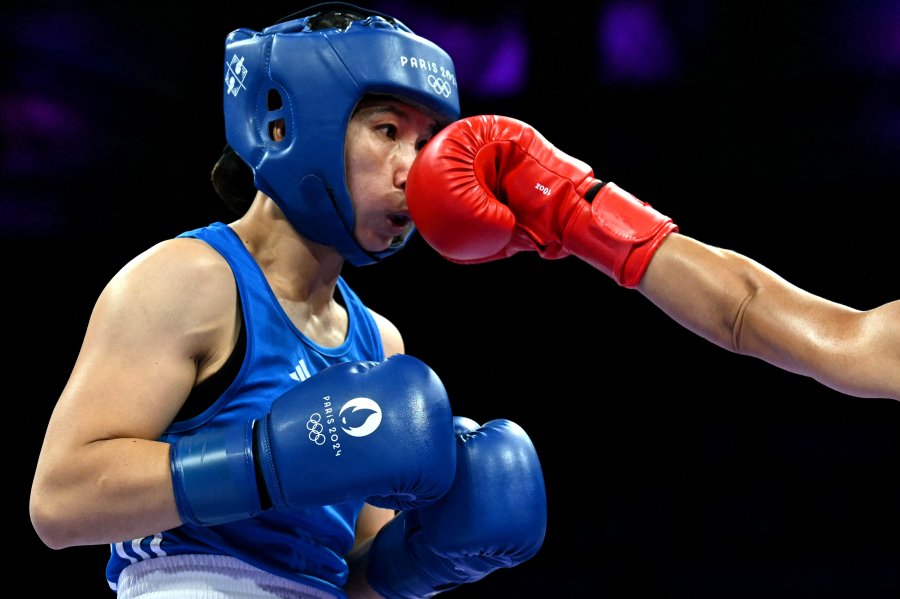 Vietnam's Ha Thi Linh takes a punch from Tonga's Feofaaki Epenisa in an Olympic boxing match