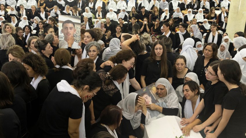 Mourners attend a funeral for ten of the victims of yesterday's rocket attack on July 28, 2024 in Majdal Shams, Golan Heights. Yesterday, 12 young people were killed in a rocket attack on a football pitch in this Druze Arab community. Israel blamed the militant group Hezbollah, with which it has been regularly exchanging fire across the Lebanese border, although the group denied responsibility. Today, Israel said it had retaliated with strikes against Hezbollah targets "deep inside Lebanese territory."