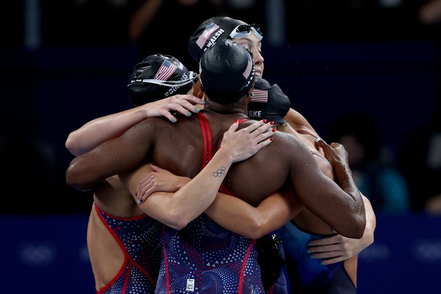 Kate Douglass, Gretchen Walsh, Torri Huske and Simone Manuel of Team United States celebrate after winning silver