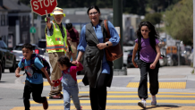 As a school crossing guard of seven years, Joel Kamisher, regularly helps San Francisco students and their families safely navigate traffic. Kamisher is also the union representative for the city's roughly 170 school crossing guards.