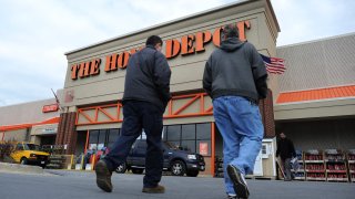 Shoppers walk towards a Home Depot store in Silver Spring, Maryland.