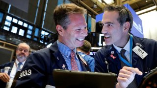 Traders work on the floor at the New York Stock Exchange.