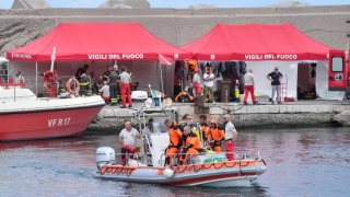 The fire service dive team leaves port heading for the dive site for the Bayesian off the coast of Porticello, Sicily, on the third day of the search for six tourists missing after the luxury yacht Bayesian sank in a storm on Monday whilst moored around half a mile off the coast. 