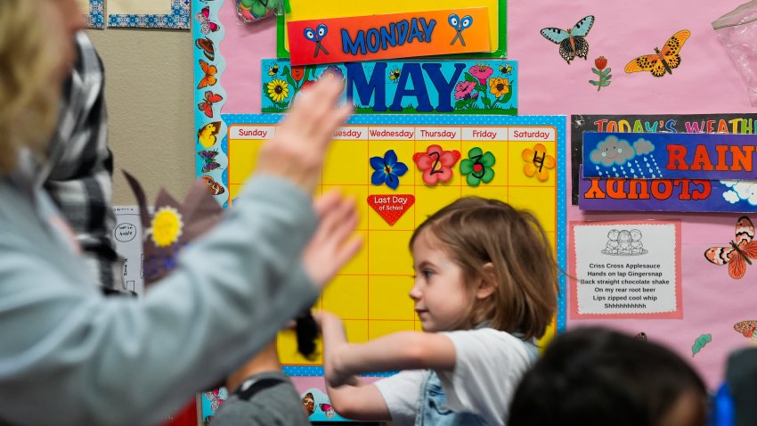 The day of the school’s closure is marked on a calendar as children, including Mariah Wallen, 5, march in a circle to music in the Stars classroom at the Meadow Lakes CCS Early Learning, a Head Start center, Monday, May 6, 2024, in Wasilla, Alaska.