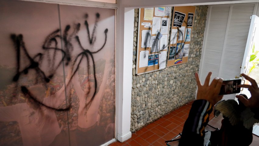 Graffiti covers the wall inside the election campaign headquarters of opposition leader Maria Corina Machado and presidential candidate Edmundo Gonzalez the day after it was ransacked overnight in Caracas, Venezuela, Friday, Aug. 2, 2024. Officials have threatened to arrest Machado who has gone into hiding five days after the disputed presidential election.