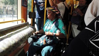 a 57-year-old volunteer for the Paris 2024 Olympic and Paralympic Games, rides on the Tramway T3a line