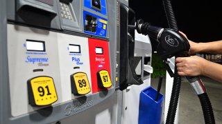 FILE: A nozzle is replaced on a fuel dispenser at a gas station in La Puente, California, on September 7, 2023. (Photo by Frederic J. BROWN / AFP) (Photo by FREDERIC J. BROWN/AFP via Getty Images)