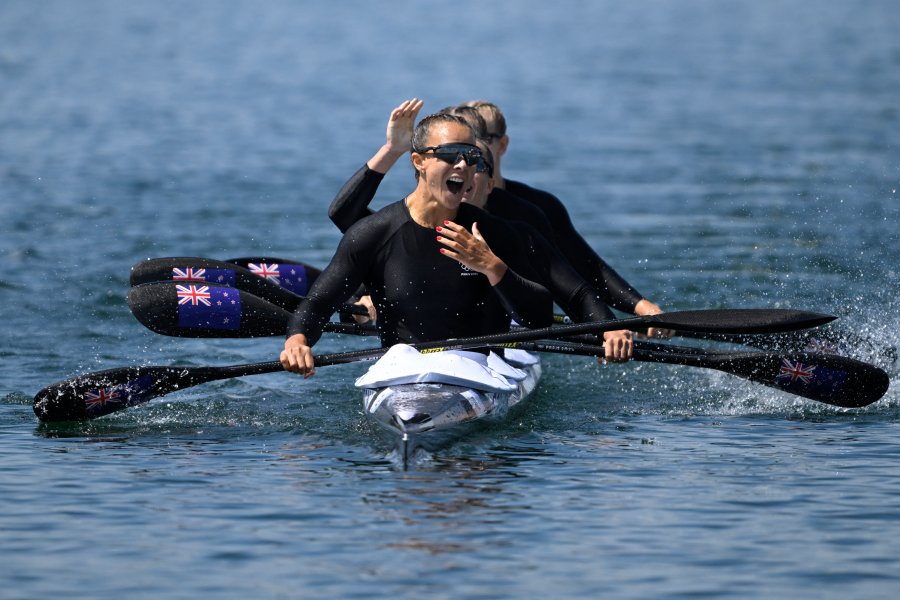 New Zealand's gold medallists Lisa Carrington, Alicia Hoskin, Olivia Brett and Tara Vaughan celebrate their victory in the women's kayak four 500m final of the canoe sprint competition at Vaires-sur-Marne Nautical Stadium in Vaires-sur-Marne during the Paris 2024 Olympic Games on August 8, 2024