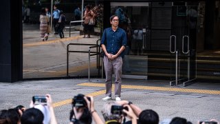 Chung Pui-kuen, former editor-in-chief of the now-defunct pro-democracy publications Stand News, leaves the District Courts after being granted bail following a verdict hearing in Hong Kong, China