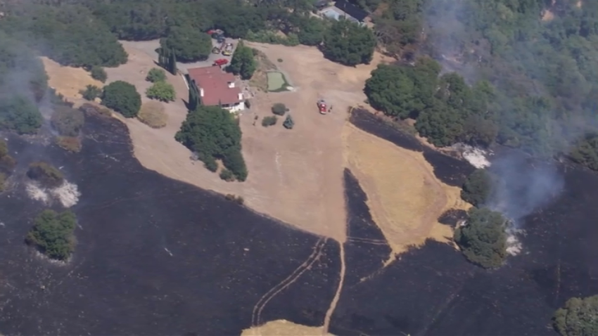 Firefighters mop up a brush fire in Solano County.