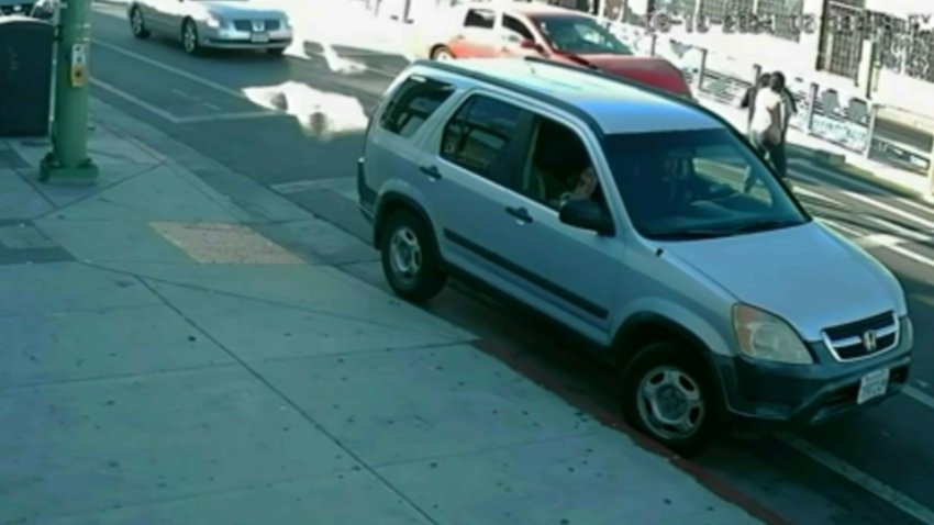 A screenshot from surveillance video shows the moment just before a speeding car hits a teen and her mother in a crosswalk in Oakland on Aug. 19.