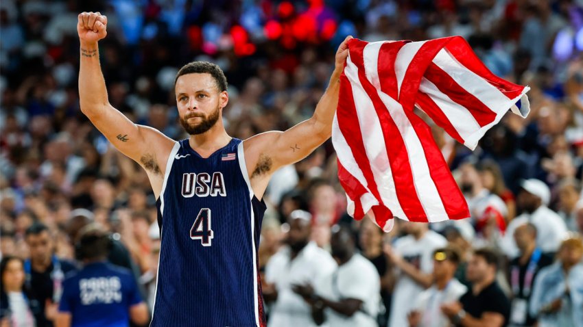 Steph Curry waves the American flag