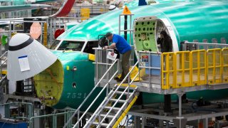 Employees work on Boeing 737 MAX airplanes at the Boeing Renton Factory in Renton, Washington on March 27, 2019.