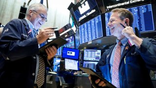 Traders work on the floor at the New York Stock Exchange.