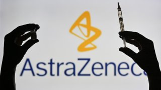 An illustrative image of a person holding a medical syringe and a Covid-19 vaccine vial in front of the the AstraZeneca logo displayed on a screen.
On Wednesday, January 12, 2021, in Edmonton, Alberta, Canada. (Photo by Artur Widak/NurPhoto via Getty Images)