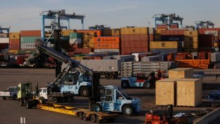 FILE - Shipping yard equipment sits parked near containers at the Port of Virginia APM Terminal in Portsmouth, Virginia.