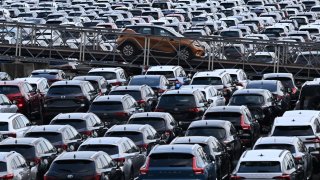 New cars of various brands are parked for export on the parking of a car terminal at the harbour of Duisburg, western Germany, on August 7, 2024.