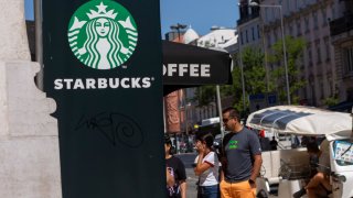 A general view of people walking by a Starbucks Coffee store in Lisbon, Portugal, on August 24, 2024.