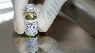 A pharmacist holds a vial of lenacapavir, the new HIV prevention injectable drug.