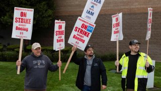 Boeing factory workers gather on a picket line during the first day of a strike near the entrance of a production facility in Renton, Washington, U.S., September 13, 2024. 