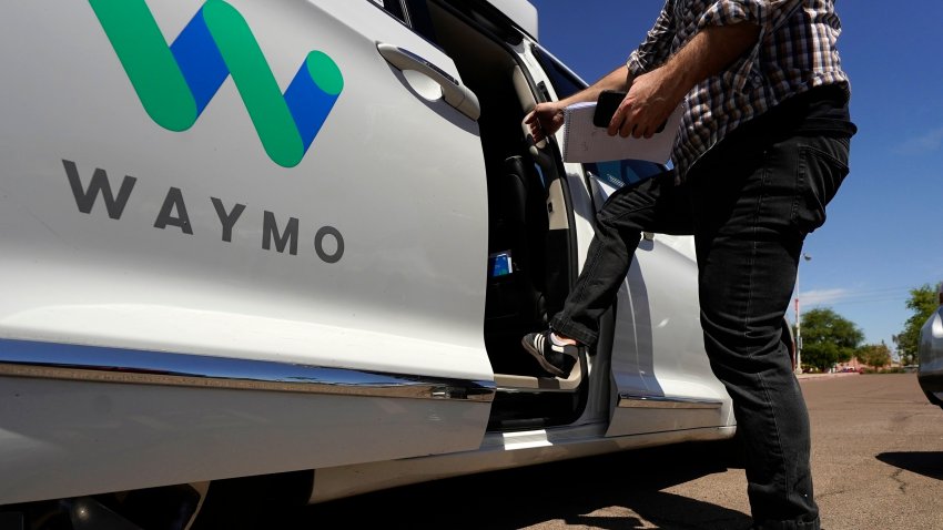 FILE – A Waymo minivan arrives to pick up passengers for an autonomous vehicle ride, Wednesday, April 7, 2021, in Mesa, Ariz.