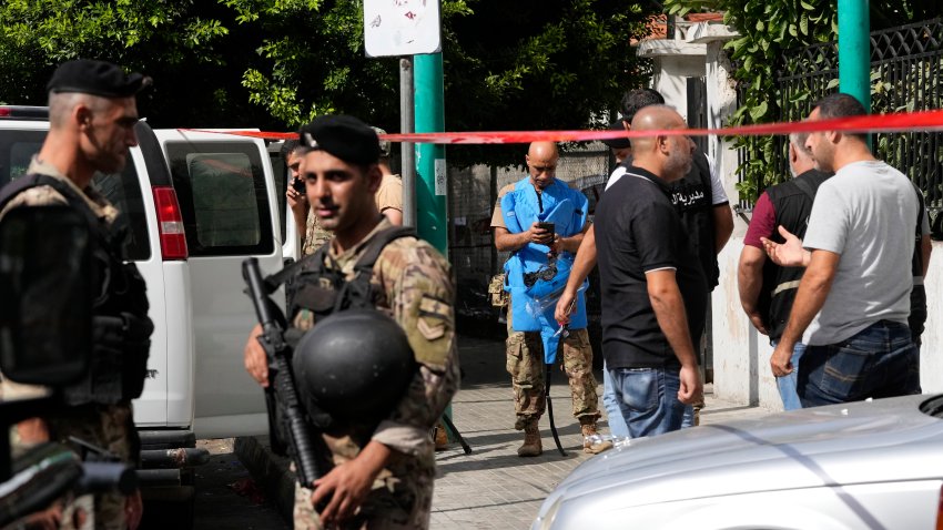 Police tape cordons off the area as security members and an explosive specialist investigate a suspicious device in Beirut, Thursday, Sept. 19, 2024.