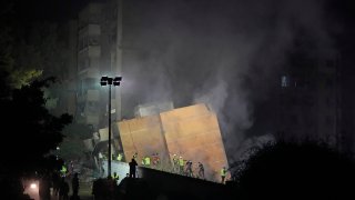 Rescuers arrive at the site of an Israeli airstrike in Beirut’s southern suburbs, Friday, Sept. 27, 2024.