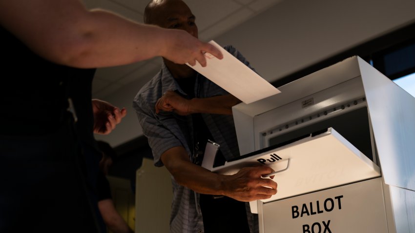 File. A voter drops their ballot into a ballot box at the Minneapolis Elections & Voter Services building on September 20, 2024 in Minneapolis, Minnesota. Today is the first day of early voting in Minnesota ahead of the 2024 presidential election this November.