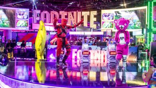 Character actors from the Epic Games Fortnite video game dance during the E3 Electronic Entertainment Expo in Los Angeles on June 12, 2019.