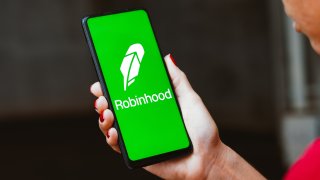 Tthe Robinhood logo is displayed on a smartphone screen.