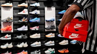 An employee carries shoe boxes at the Footlocker retail store in the Barton Creek Square Mall on August 28, 2024 in Austin, Texas. 