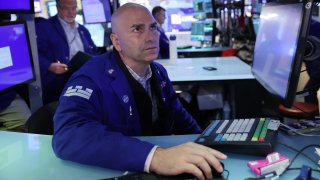 Traders work on the floor of the New York Stock Exchange during morning trading on September 23, 2024 in New York City.