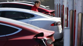 Tesla electric vehicles (EVs) recharge at a Tesla Supercharger station on September 23, 2024 in Pasadena, California. 