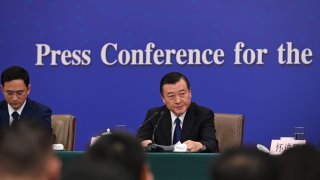 09 March 2024, China, Peking: Ni Hong (r.), China’s Minister of Housing and Rural Development, speaks at a press conference. 