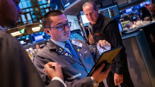 Traders work on the floor of the New York Stock Exchange on Oct. 22, 2024.