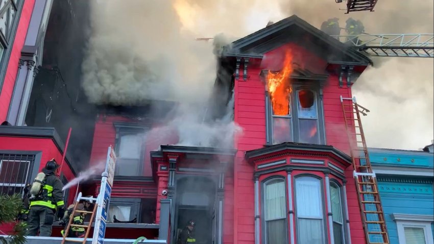 Firefighters battle a fire on the 3100 block of 22nd Street in San Francisco.