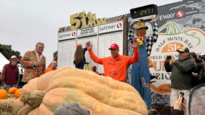 Travis Gienger of Nowthen Minn. stands with his 2,471-pound pumpkin.