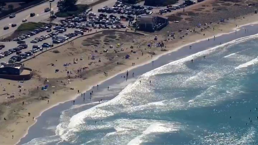 People flock to a beach in the Bay Area during a fall heat wave.